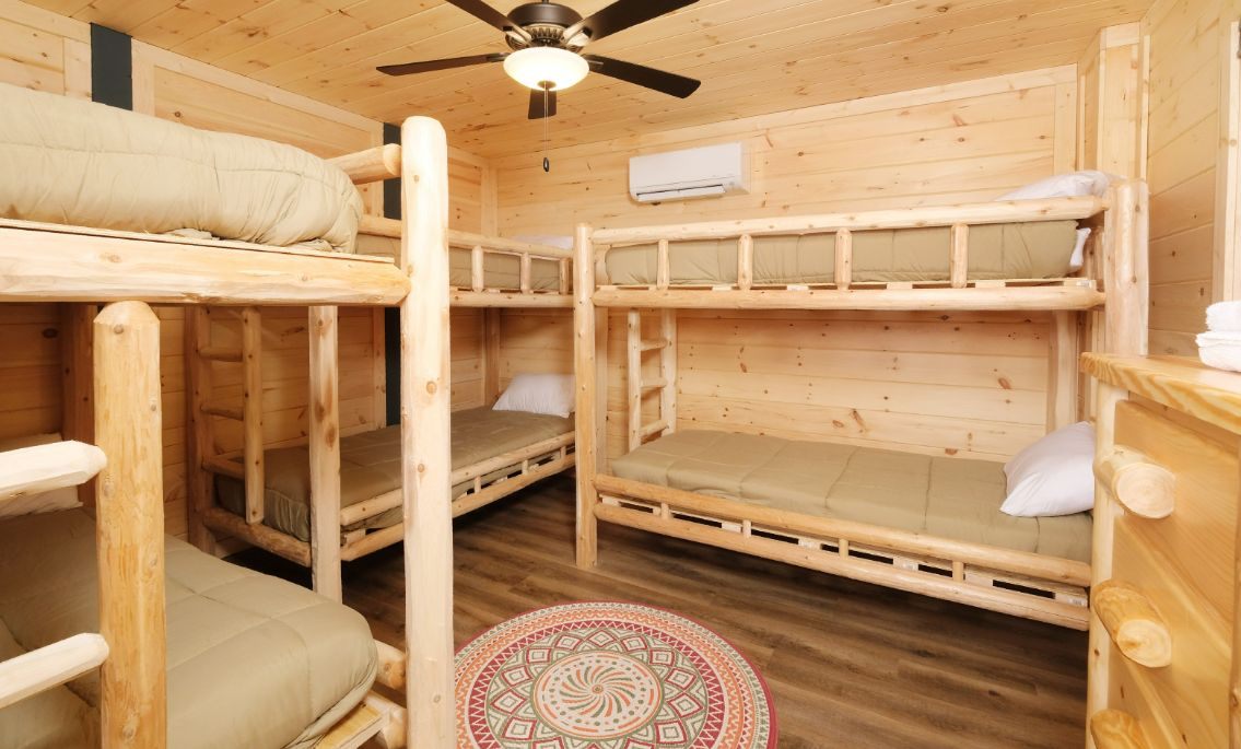 Bunk room with three twin XL bunks