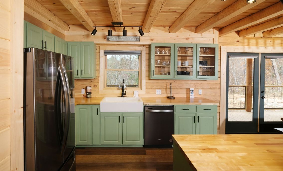 Kitchen with sage green cabinets and butcher block counters